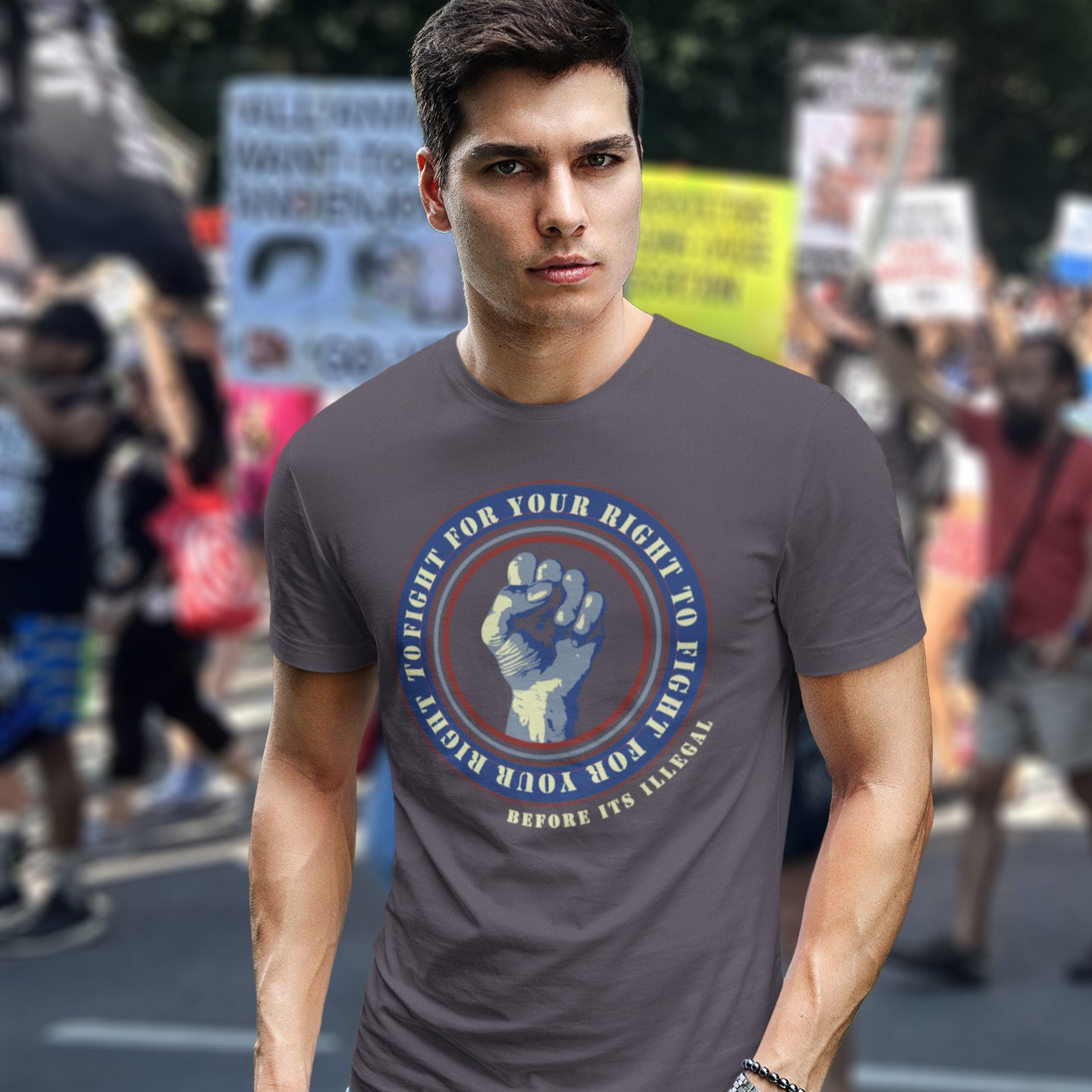 Man wearing an anthracite t-shirt. A civil rights t-shirt reminding us not to take our freedom for granted. Fight for your right to demonstrate before it's made illegal. Made from 100% organic ring-spun cotton, this anti-establishment t-shirt is unisex, high-quality, super comfy, and best of all, eco-friendly. t-shirt with a graphic design in a protest setting