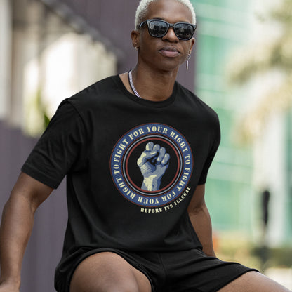 Person wearing a black t-shirt with a graphic design outdoors. A civil rights t-shirt reminding us not to take our freedom for granted. Fight for your right to demonstrate before it's made illegal. Made from 100% organic ring-spun cotton, this anti-establishment t-shirt is unisex, high-quality, super comfy, and best of all, eco-friendly.