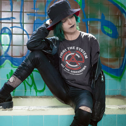 Person wearing a dark t shirt t, sitting against a graffiti-covered wall. This anti establishment t shirt speaks out against capitalism and warns not to be side tracked by the individual problems created by the overall system. Capitalism is responsible for so many of societies problems, do not accept it. Join our community and be proud to wear the shirt. Made from 100% organic ring-spun cotton, this anti capitalist t shirt is unisex, high-quality, super comfy, and best of all, eco-friendly.