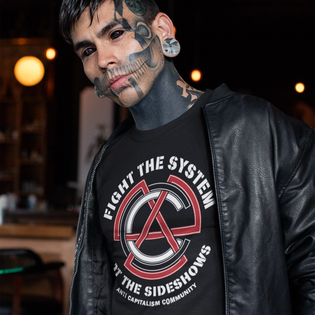 Man wearing a black leather jacket and a t-shirt with a graphic design and text. This anti establishment t shirt speaks out against capitalism and warns not to be side tracked by the individual problems created by the overall system. Capitalism is responsible for so many of societies problems, do not accept it. Join our community and be proud to wear the shirt. Made from 100% organic ring-spun cotton, this anti capitalist t shirt is unisex, high-quality, super comfy, and best of all, eco-friendly.
