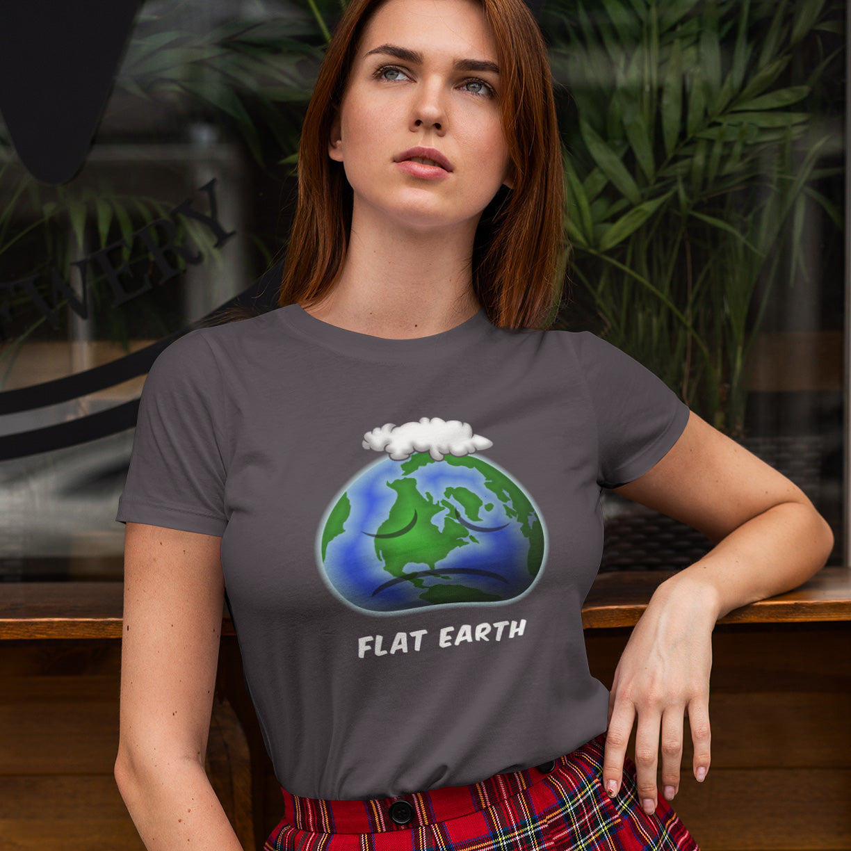 Woman wearing a t-shirt with a 'Flat Earth' graphic design. This funny conspiracy theorist t shirt plays on the idea of the earth being flat. Could it just be a little bored or depressed. Made from 100% organic ring-spun cotton, this funny flat earth conspiracy theory t shirt is unisex, high-quality, super comfy, and best of all, eco-friendly.