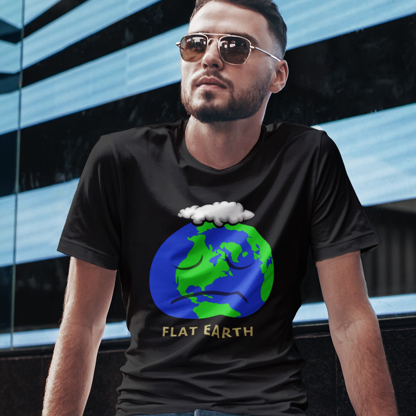Man wearing a black t-shirt with a 'Flat Earth' graphic design. This funny conspiracy theorist t shirt plays on the idea of the earth being flat. Could it just be a little bored or depressed. Made from 100% organic ring-spun cotton, this funny flat earth conspiracy theory t shirt is unisex, high-quality, super comfy, and best of all, eco-friendly.