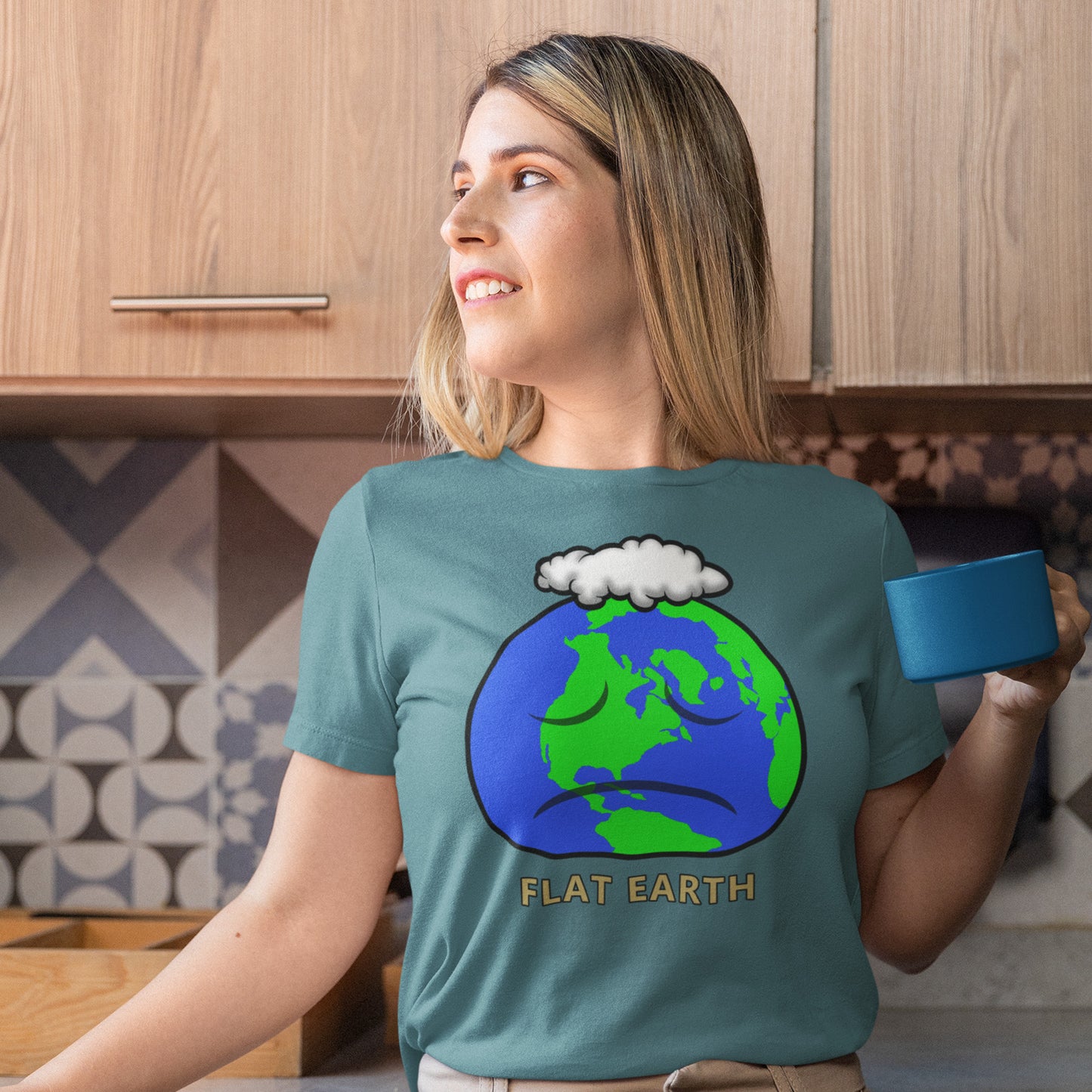 Woman wearing a stargazer t-shirt with a 'Flat Earth' graphic in a kitchen. This funny conspiracy theorist t shirt plays on the idea of the earth being flat. Could it just be a little bored or depressed. Made from 100% organic ring-spun cotton, this funny flat earth conspiracy theory t shirt is unisex, high-quality, super comfy, and best of all, eco-friendly.