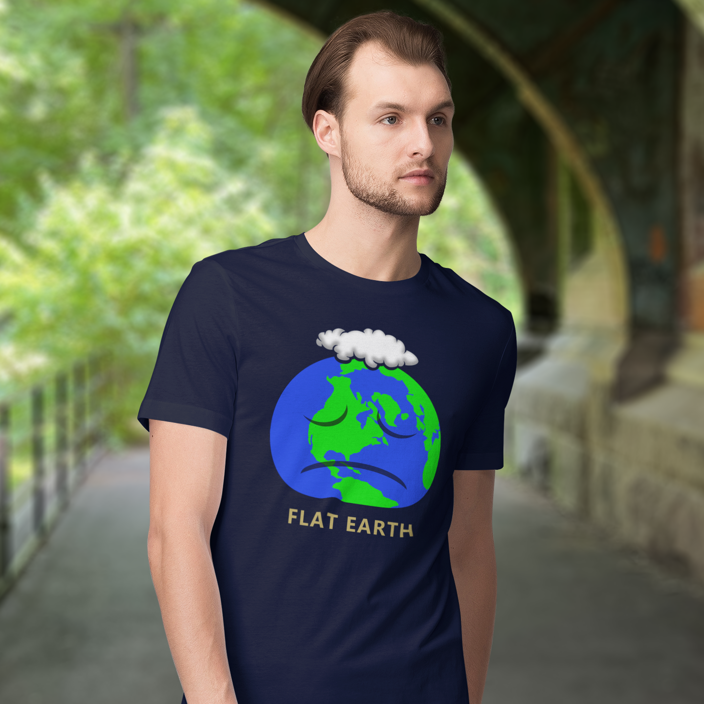 Man wearing a French navy blue t-shirt with a 'Flat Earth' graphic design outdoors. This funny conspiracy theory t-shirt plays on the idea of the earth being flat. Could it just be a little bored or depressed. Made from 100% organic ring-spun cotton, this funny flat earth theory t-shirt is unisex, high-quality, super comfy, and best of all, eco-friendly.