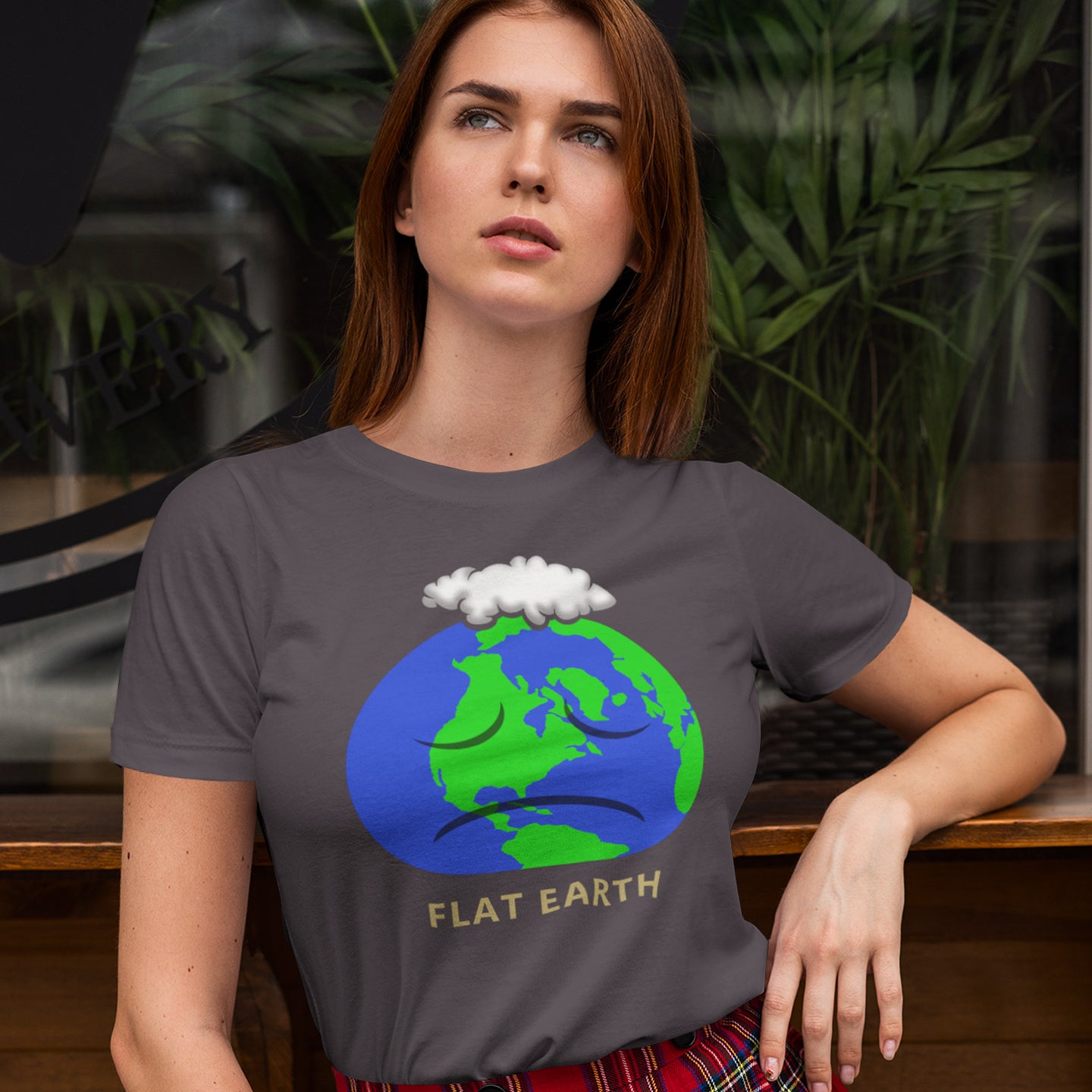 Person wearing a t-shirt with a 'Flat Earth' graphic design. This funny conspiracy theory t-shirt plays on the idea of the earth being flat. Could it just be a little bored or depressed. Made from 100% organic ring-spun cotton, this funny flat earth theory t-shirt is unisex, high-quality, super comfy, and best of all, eco-friendly.