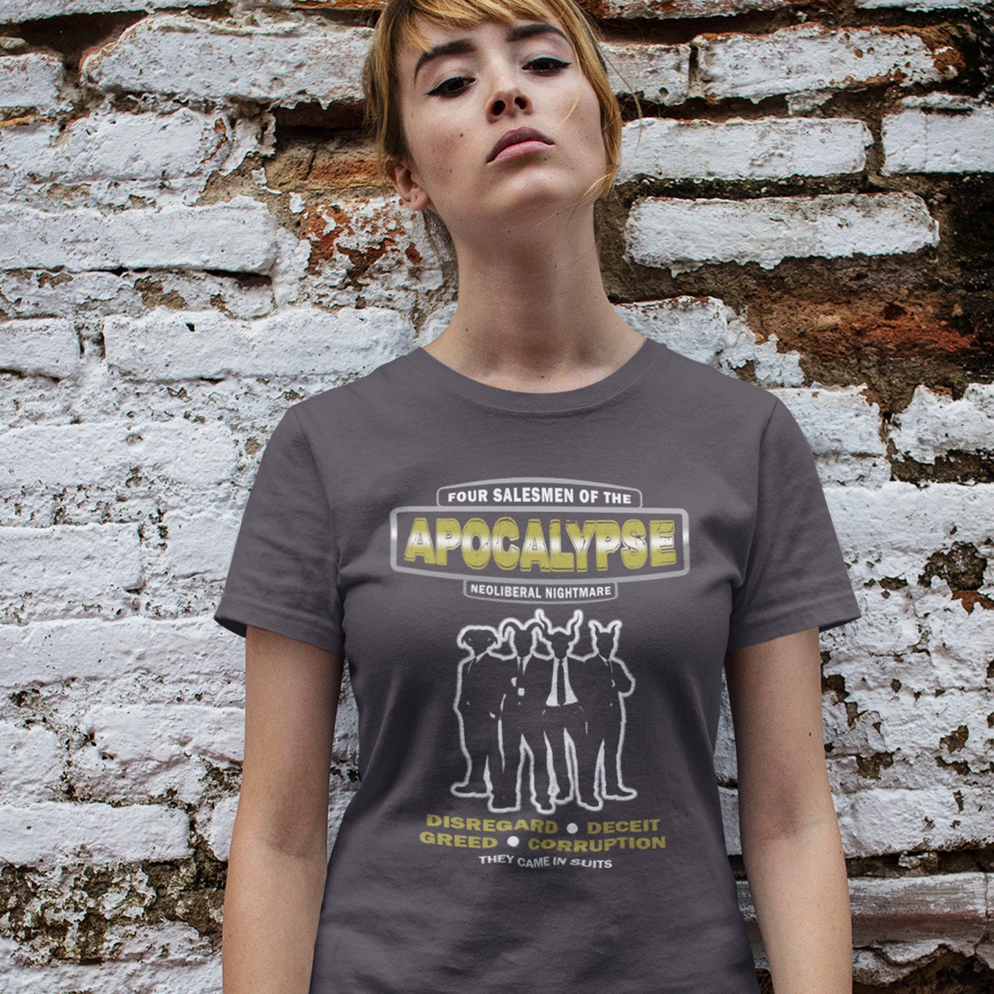 Person wearing a t-shirt with graphic design against a textured wall . An anti capitalism t shirt with a biblical undertone. A satirical design looking at how neoliberalism could bring on the downfall of civilised society and the form it will take. Made from 100% organic ring-spun cotton, this non conformist t shirt is a total must-have. It's high-quality, super comfy, and best of all—eco-friendly.background