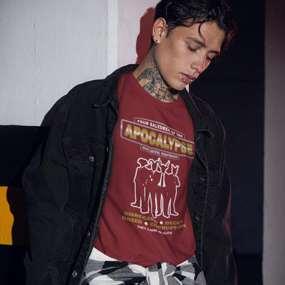 Person wearing a burgundy t-shirt with graphic design and text, standing against a dark wall. An anti capitalism t shirt with a biblical undertone. A satirical design looking at how neoliberalism could bring on the downfall of civilised society and the form it will take. Made from 100% organic ring-spun cotton, this non conformist t shirt is a total must-have. It's high-quality, super comfy, and best of all—eco-friendly.