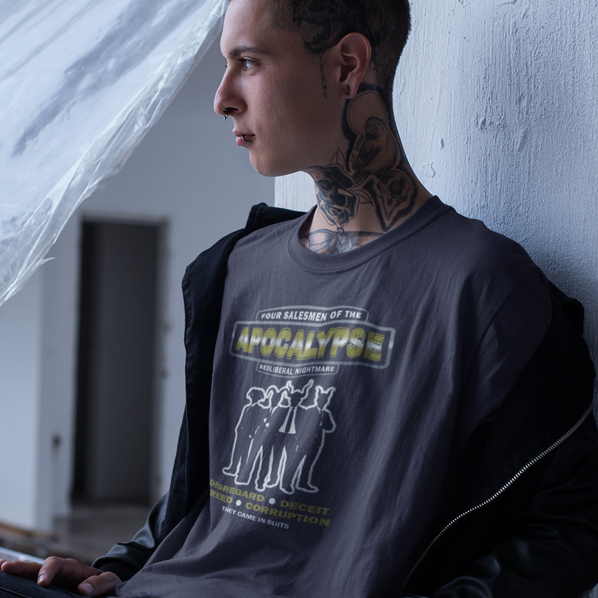 Person wearing a graphic t-shirt leaning against a wall indoors. A political t-shirt with a biblical undertone. A satirical design looking at how neoliberalism could bring on the downfall of civilised society and the form it will take. Made from 100% organic ring-spun cotton, this unisex political t-shirt is a total must-have. It's high-quality, super comfy, and best of all—eco-friendly.