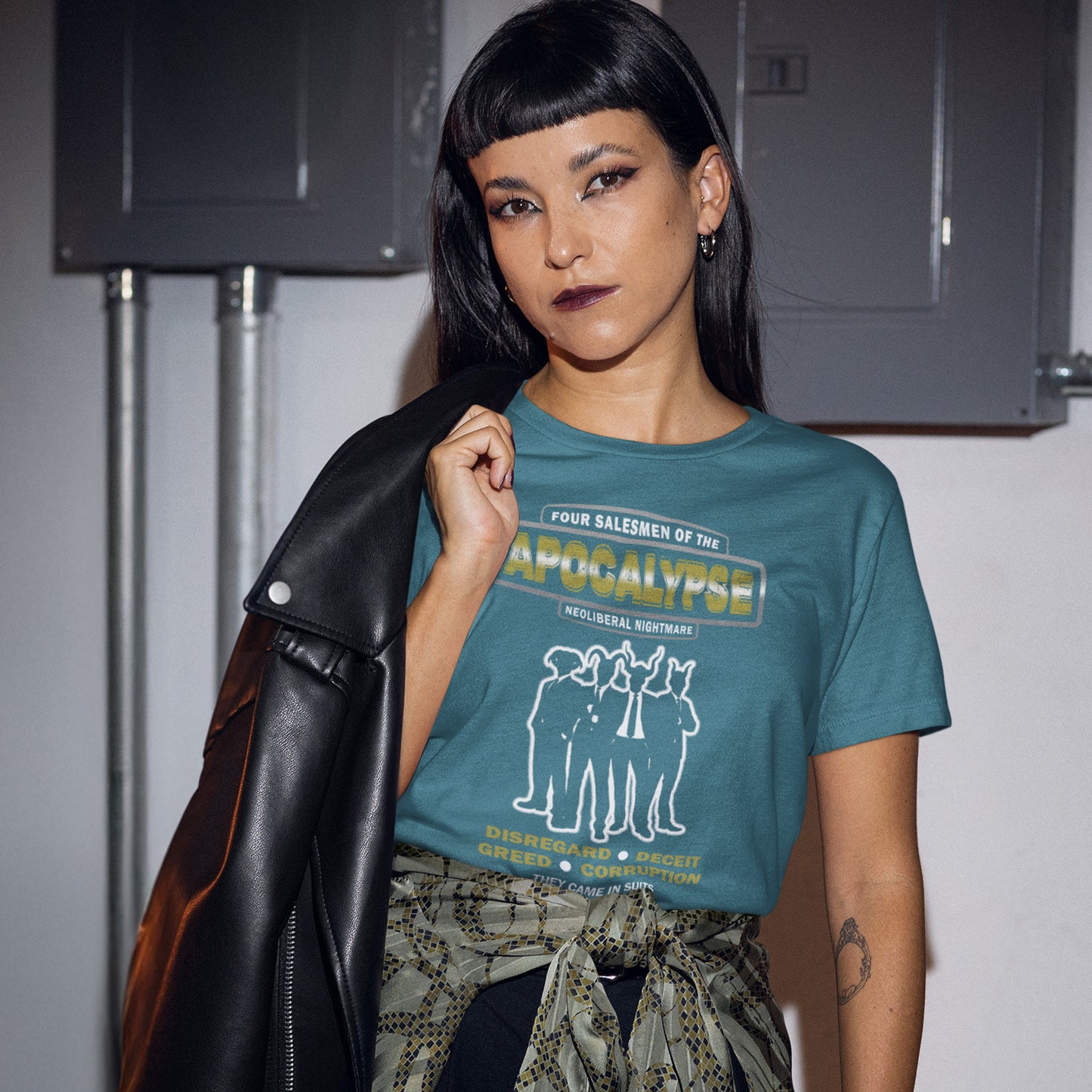 Person wearing a blue t-shirt with graphic design and text, standing against a plain background. A political t-shirt with a biblical undertone. A satirical design looking at how neoliberalism could bring on the downfall of civilised society and the form it will take. Made from 100% organic ring-spun cotton, this unisex political t-shirt is a total must-have. It's high-quality, super comfy, and best of all—eco-friendly.