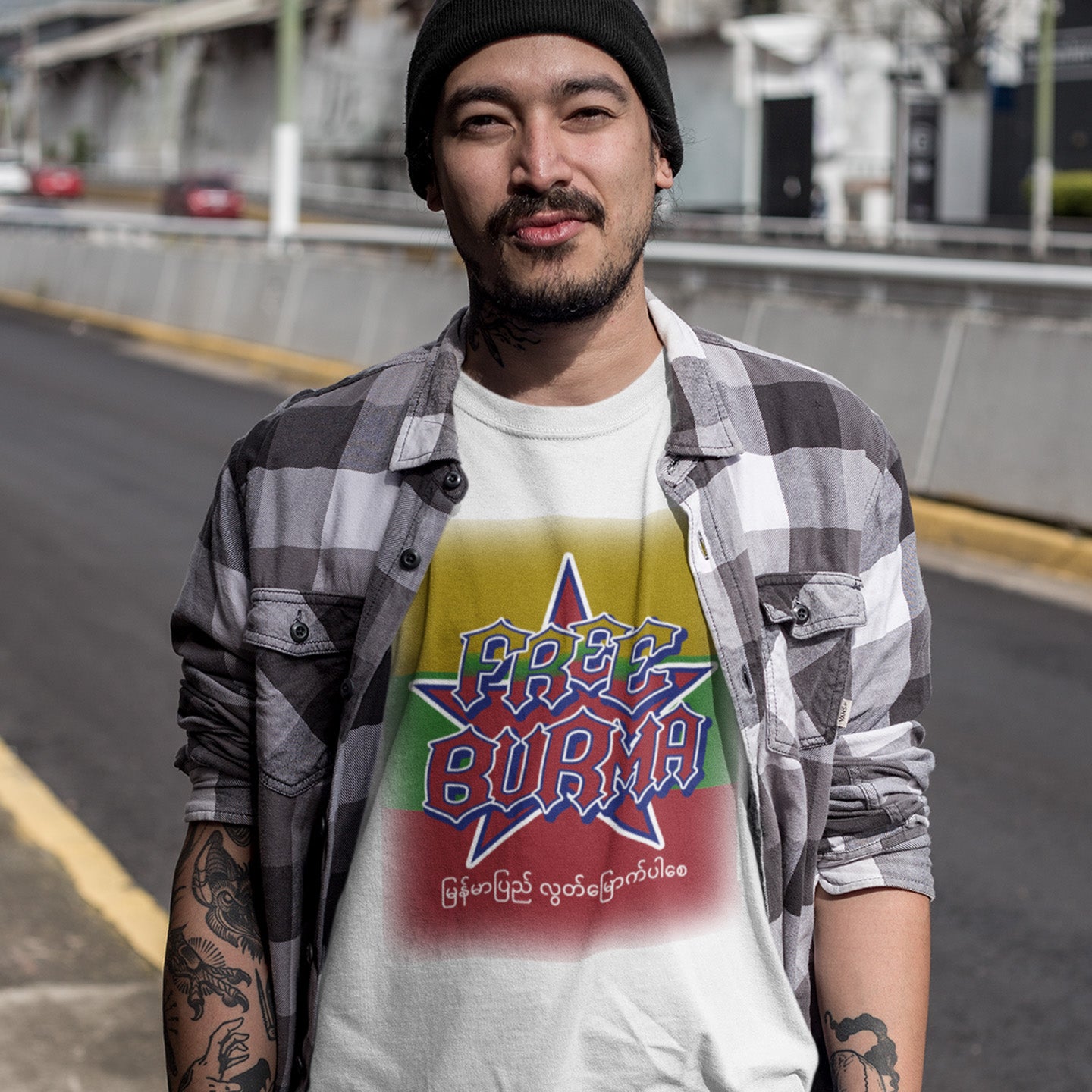 Man wearing a shirt with 'Free Burma' text and design outdoors. A free Burma human rights t-shirt opposing the military dictatorship ruining a beautiful country. This liberation t shirt design highlights the atrocities that have been going on way to long and mostly ignored by the Western World. Show your support. Made from 100% organic ring-spun cotton, this human rights t shirt is unisex, high-quality, super comfy, and best of all, eco-friendly.