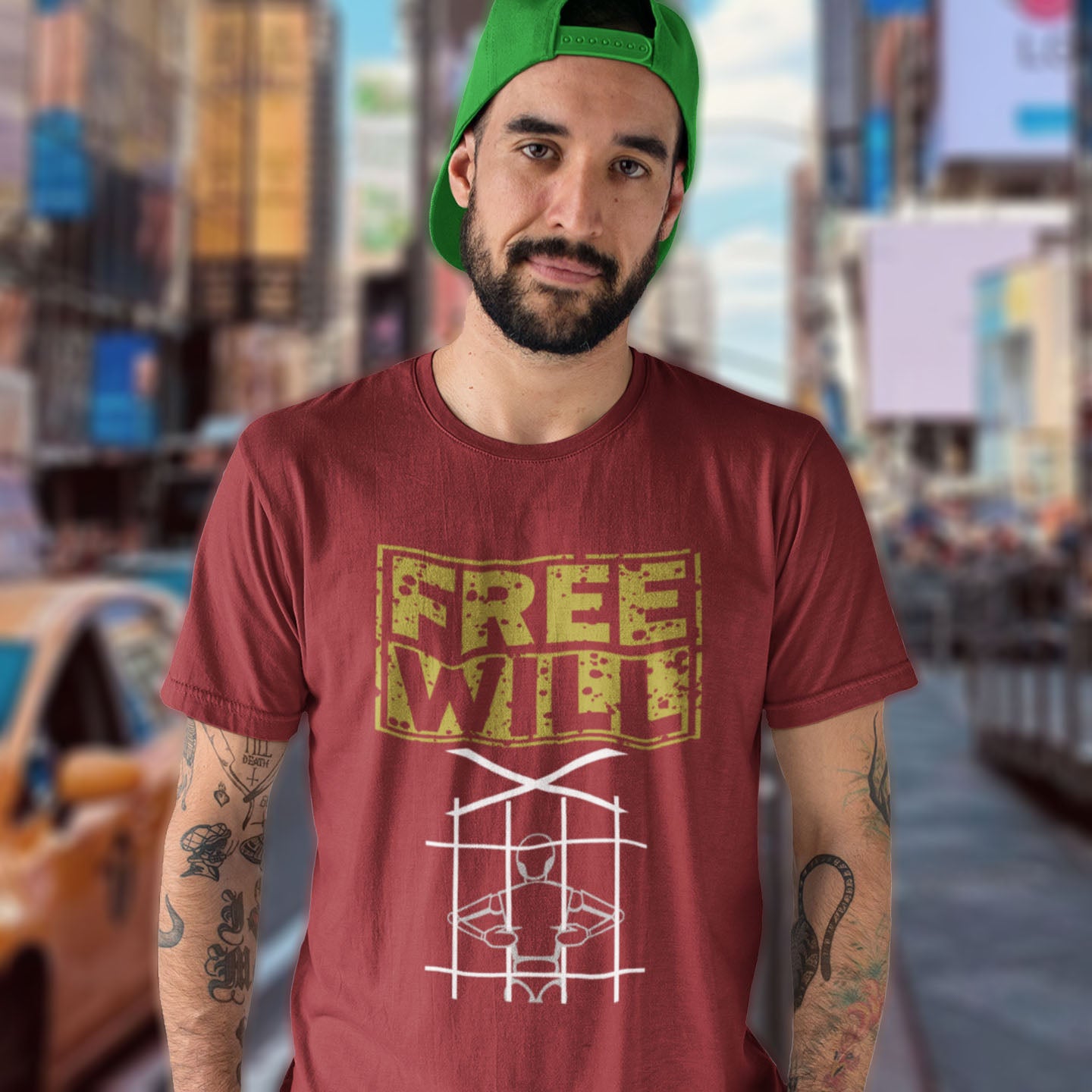 Man wearing a burgundy t-shirt with 'FREE WILF' design in Times Square, New York. A civil liberties t shirt design to promote independent thought and self awareness. If you are feeling overwhelmed by influence, join the 'free will' movement. Made from 100% organic ring-spun cotton, this social awareness t-shirt is unisex, high-quality, super comfy, and best of all, eco-friendly.