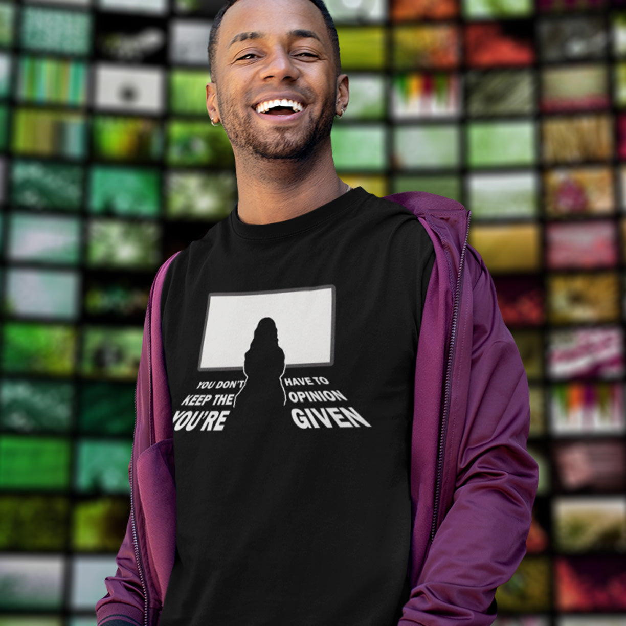 Man wearing a black t-shirt, standing in front of a colourful grid background. A non conformist t shirt design to promote self awareness. In a age of external influence. especially from mass media, lets not forget that you still own the right to investigate and form your own opinion. A design to promote independent thought and the need to think outside the box. Made from 100% organic ring-spun cotton, this self worth t shirt is unisex, high quality, super comfy, and best of all, eco-friendly.