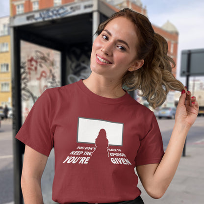 Woman wearing a burgundy t-shirt with a graphic design on a city street background. A non conformist t shirt design to promote self awareness. In a age of external influence. especially from mass media, lets not forget that you still own the right to investigate and form your own opinion. A design to promote independent thought and the need to think outside the box. Made from 100% organic ring-spun cotton, this self worth t shirt is unisex, high quality, super comfy, and best of all, eco-friendly.