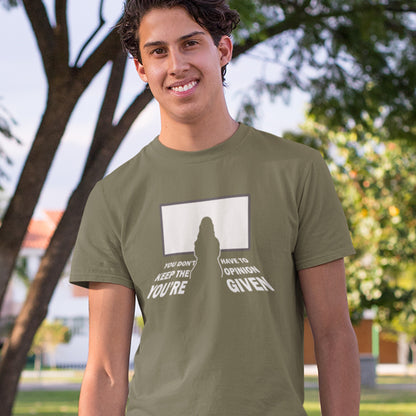 Person wearing a khaki t-shirt with a graphic design outdoors. A non conformist t shirt design to promote self awareness. In a age of external influence. especially from mass media, lets not forget that you still own the right to investigate and form your own opinion. A design to promote independent thought and the need to think outside the box. Made from 100% organic ring-spun cotton, this self worth t shirt is unisex, high quality, super comfy, and best of all, eco-friendly.