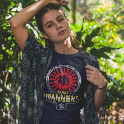 Person wearing a t-shirt with a graphic design in a forest setting. A sign of the times t shirt design suggesting that good manners are dying out. A dig at modern social awareness and lack of politeness.  Made from 100% organic ring-spun cotton, this social awareness t shirt is unisex, high-quality, super comfy, and best of all, eco-friendly.