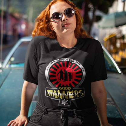 Person wearing a black t-shirt with a graphic design, standing in front of a vintage car. A sign of the times t shirt design suggesting that good manners are dying out. A dig at modern social awareness and lack of politeness.  Made from 100% organic ring-spun cotton, this social awareness t shirt is unisex, high-quality, super comfy, and best of all, eco-friendly.
