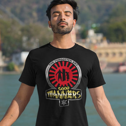 Man wearing a black t-shirt with a graphic design in front of a blurred natural background. A sarcastic and satirical t-shirt design suggesting that good manners are dying out. A dig at modern social awareness and lack of politeness. Made from 100% organic ring-spun cotton, this social awareness t-shirt is unisex, high-quality, super comfy, and best of all, eco-friendly.