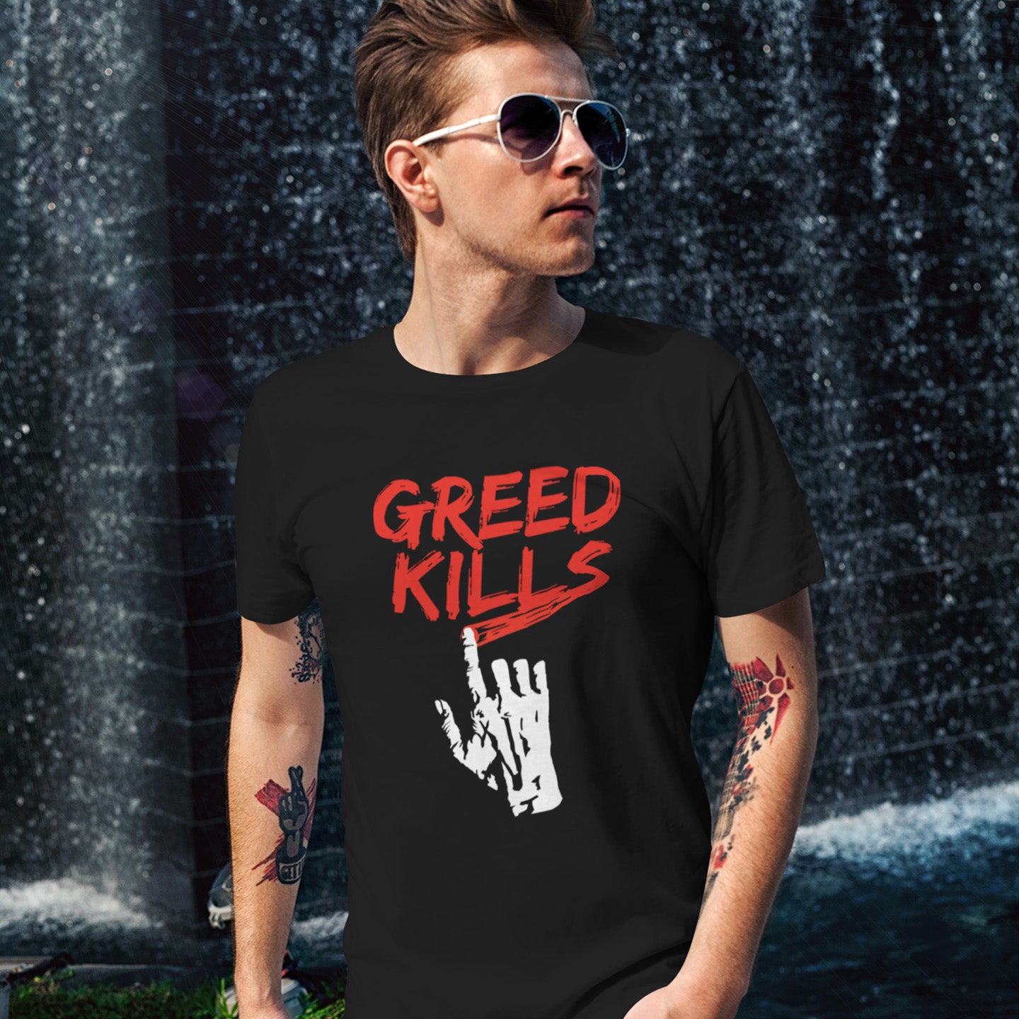 Person wearing a black t-shirt with 'Greed Kills' graphic design outdoors. This anti capitalism t shirt opposes greed, the slow-creeping, strong-holding virus that has been with us since the beginning of time, yet we still can't find a cure. A morality t-shirt design promoting social awareness of the effect of greed on the world. Made from 100% organic ring-spun cotton, this ant capitalist t shirt is unisex, high-quality, super comfy, and best of all, eco-friendly.