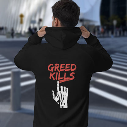 Person wearing a black hoodie with 'GREED KILLS' text and hand gesture on the back, standing outdoors. An anti-capitalism hoodie design focusing on greed. It's the slow-creeping, strong-holding virus that has been with us since the beginning of time, yet we still can't find a cure. Comfortable and practical. It's extra soft and has a convenient front pouch pocket. Made from organic cotton and recycled polyester, this non conformist hoodie is a great eco-friendly choice for the anti-capitalist.