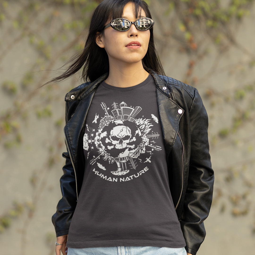 Person wearing a black t-shirt with a skull design and 'Human Nature' text, standing outdoors. This save the world t shirt claims human nature is nowhere near as good as mother nature. It's not only about environmental issues. How do we save the planet from human nature. Made from 100% organic ring-spun cotton, this save the earth t shirt is unisex, high-quality, super comfy, and best of all, eco-friendly.