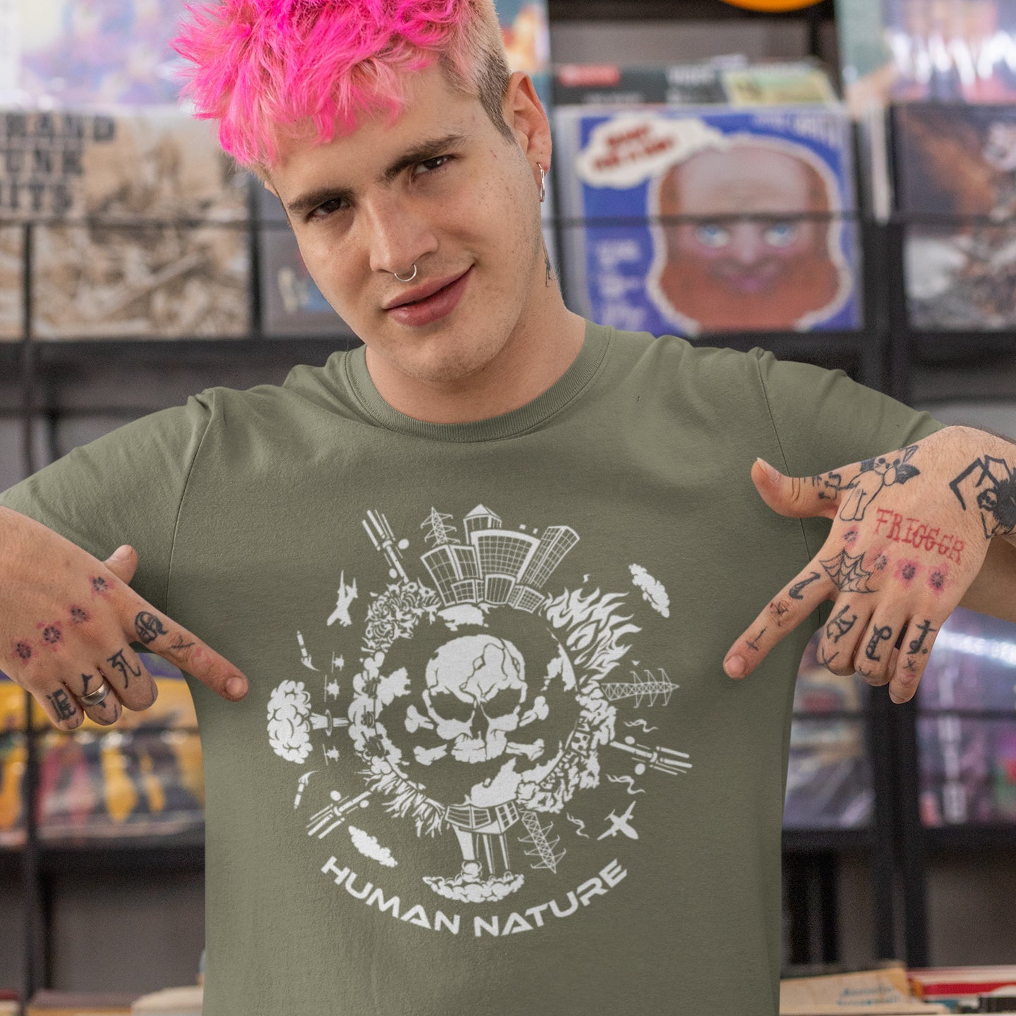 Person wearing a khaki t-shirt with a skull design and 'Human Nature' text, standing in a store. This save the world t shirt claims human nature is nowhere near as good as mother nature. It's not only about environmental issues. How do we save the planet from human nature. Made from 100% organic ring-spun cotton, this save the earth t shirt is unisex, high-quality, super comfy, and best of all, eco-friendly.