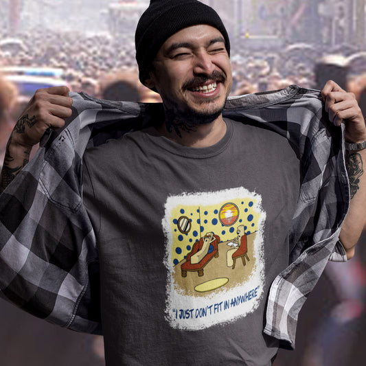Man wearing a t-shirt with a graphic design and text, standing in a crowd. A funny cartoon t-shirt for all you 'square pegs in round holes' out there. You are not alone. This unique design is ideal for anyone who thinks outside the box. Made from 100% organic ring-spun cotton, this witty cartoon t-shirt is unisex, high-quality, super comfy, and best of all, eco-friendly.