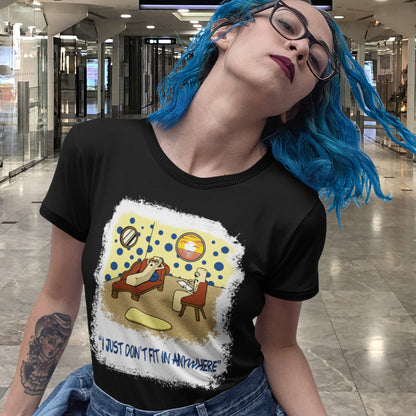 Person wearing a black t-shirt with a graphic design in a shopping centre. A funny cartoon t-shirt for all you 'square pegs in round holes' out there. You are not alone. This unique design is ideal for anyone who thinks outside the box. Made from 100% organic ring-spun cotton, this witty cartoon t-shirt is unisex, high-quality, super comfy, and best of all, eco-friendly.