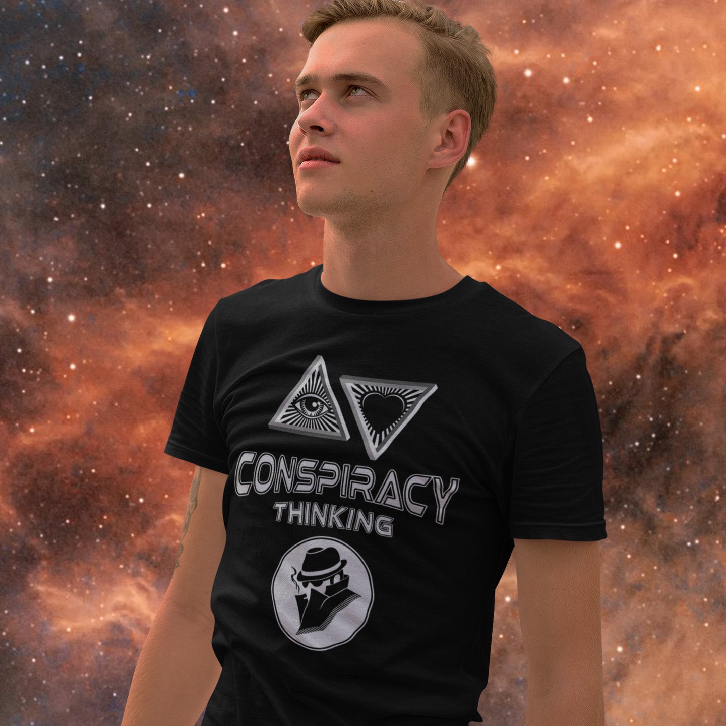 Person wearing a black t-shirt with 'Conspiracy Thinking' design against a cosmic background. A cryptic conspiracy theory t-shirt design for all of those conspiracy theory lovers out there who know it's more than a theory, it's a way of life. From Alien advocates or bigfoot believers to Cabal conspiracy theorists, an original design for all. Made from 100% organic ring-spun cotton, this conspiracy theory t-shirt is unisex, high-quality, super comfy, and best of all, eco-friendly.