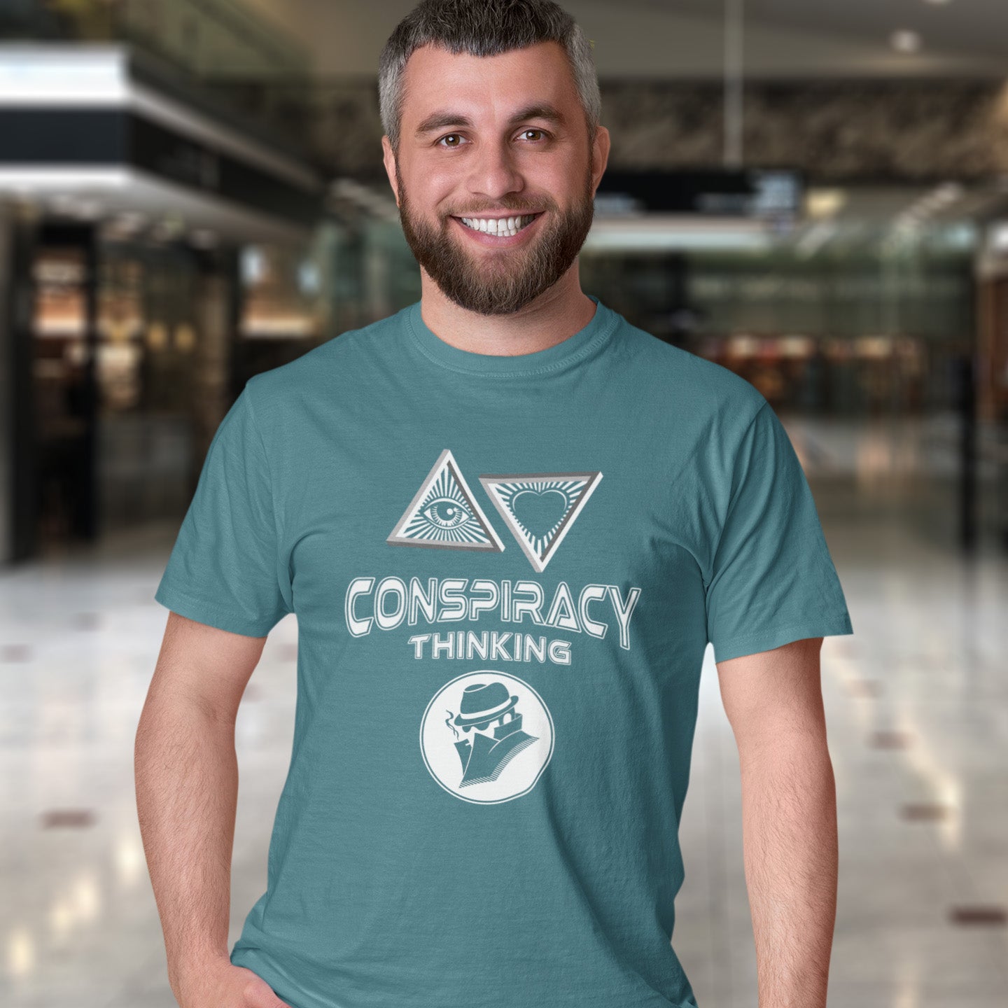 Man wearing a stargazer t-shirt with 'Conspiracy Thinking' design in an indoor setting. A cryptic conspiracy theory t-shirt design for all of those conspiracy theory lovers out there who know it's more than a theory, it's a way of life. From Alien advocates or bigfoot believers to Cabal conspiracy theorists, an original design for all. Made from 100% organic ring-spun cotton, this conspiracy theory t-shirt is unisex, high-quality, super comfy, and best of all, eco-friendly.