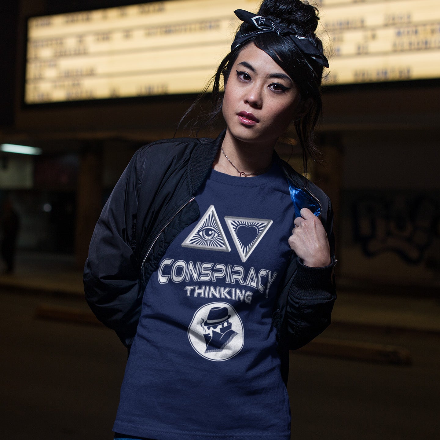 Person wearing a French navy blue shirt with conspiracy theory symbols and text. A cryptic conspiracy theory t-shirt design for all of those conspiracy theory lovers out there who know it's more than a theory, it's a way of life. From Alien advocates or bigfoot believers to Cabal conspiracy theorists, an original design for all. Made from 100% organic ring-spun cotton, this conspiracy theory t-shirt is unisex, high-quality, super comfy, and best of all, eco-friendly.