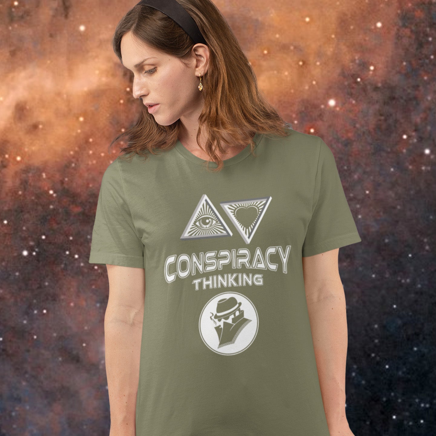 Person wearing a khaki t-shirt with 'Conspiracy Thinking' design against a cosmic background. A cryptic conspiracy theory t-shirt design for all of those conspiracy theory lovers out there who know it's more than a theory, it's a way of life. From Alien advocates or bigfoot believers to Cabal conspiracy theorists, an original design for all. Made from 100% organic ring-spun cotton, this conspiracy theory t-shirt is unisex, high-quality, super comfy, and best of all, eco-friendly.