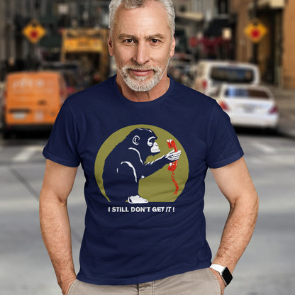 Man wearing a French navy blue t-shirt with a graphic design and text on a city street background. This anti smart phone abuse t-shirt design highlights the human obsession with smart phones and how strange it must look to an ape. An outsiders view of a world glued to mobile phones. Made from 100% organic ring-spun cotton, this anti mobile phone abuse t-shirt is unisex, high-quality, super comfy, and best of all, eco-friendly.