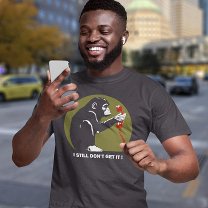 Man wearing a t-shirt with a monkey holding a phone graphic and text, standing on a city street. This anti smart phone abuse t-shirt design highlights the human obsession with smart phones and how strange it must look to an ape. An outsiders view of a world glued to mobile phones. Made from 100% organic ring-spun cotton, this anti mobile phone abuse t-shirt is unisex, high-quality, super comfy, and best of all, eco-friendly.