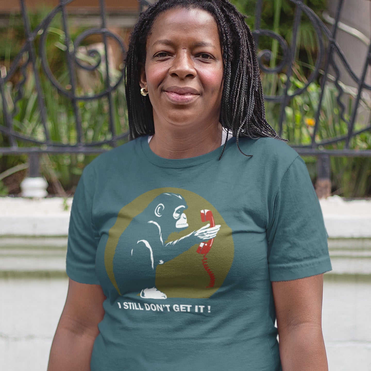 Person wearing a stargazer t-shirt with a graphic design and text outdoors. This anti smart phone abuse t-shirt design highlights the human obsession with smart phones and how strange it must look to an ape. An outsiders view of a world glued to mobile phones. Made from 100% organic ring-spun cotton, this anti mobile phone abuse t-shirt is unisex, high-quality, super comfy, and best of all, eco-friendly.