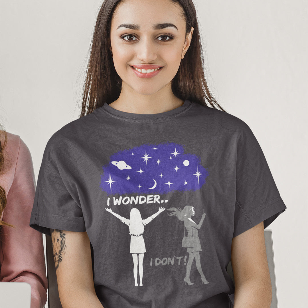 Woman wearing a t-shirt with a graphic design of two people under a starry sky with text 'I wonder... I don't!'. This anti mobile phone abuse t shirt light heartedly pokes fun at people who never look up from their phone. If you believe letting a machine do most of your thinking for you will dull your imagination, this satirical design is for you. Made from 100% organic ring-spun cotton, these anti mobile phone abuse t shirts are unisex, high quality, super comfy, and best of all, eco-friendly.