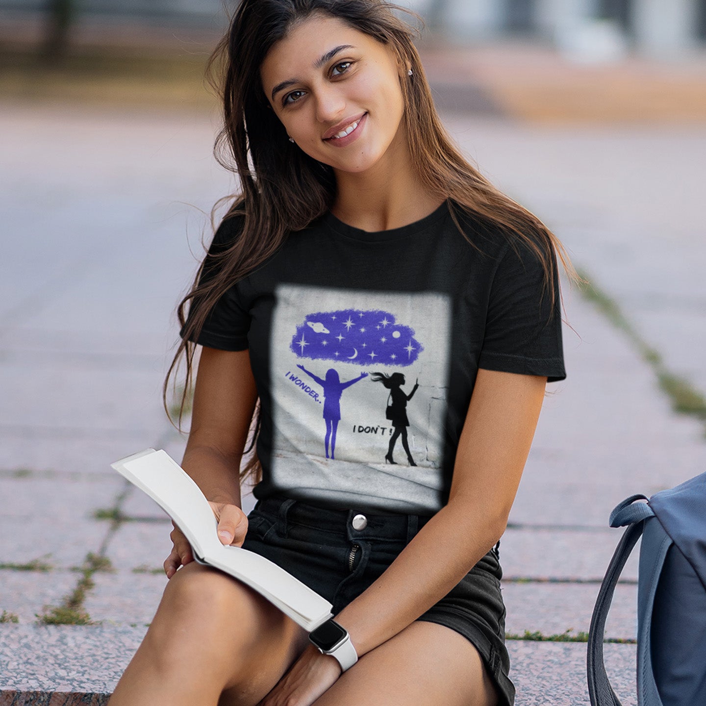 Woman wearing a black t-shirt with a graphic design, sitting outdoors. This anti mobile phone abuse t shirt light heartedly pokes fun at people who never look up from their phone. If you believe letting a machine do most of your thinking for you will dull your imagination, this satirical design is for you. Made from 100% organic ring-spun cotton, these anti mobile phone abuse t shirts are unisex, high quality, super comfy, and best of all, eco-friendly.