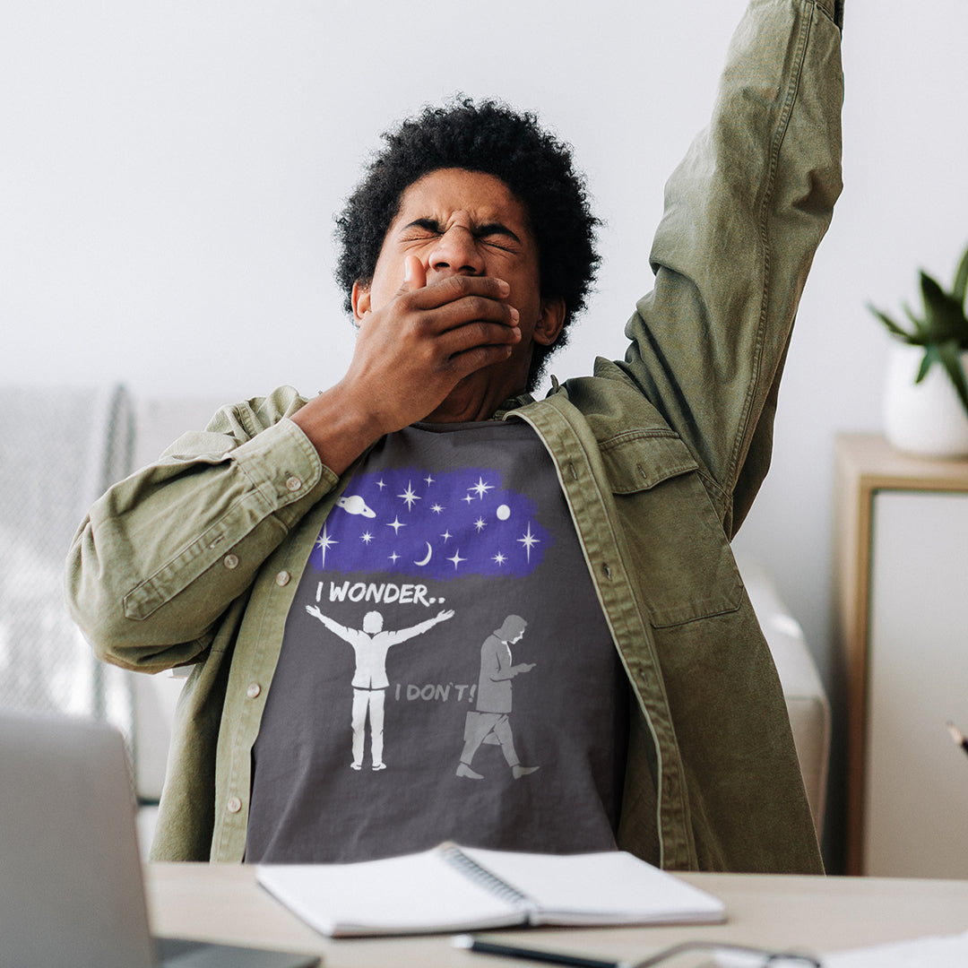 Man wearing a t-shirt with a graphic design, sitting at a desk in a home office. This anti mobile phone abuse t shirt light heartedly pokes fun at people who never look up from their phone. If you believe letting a machine do most of your thinking for you will dull your imagination, this satirical design is for you. Made from 100% organic ring-spun cotton, these anti mobile phone abuse t shirts are unisex, high quality, super comfy, and best of all, eco-friendly.