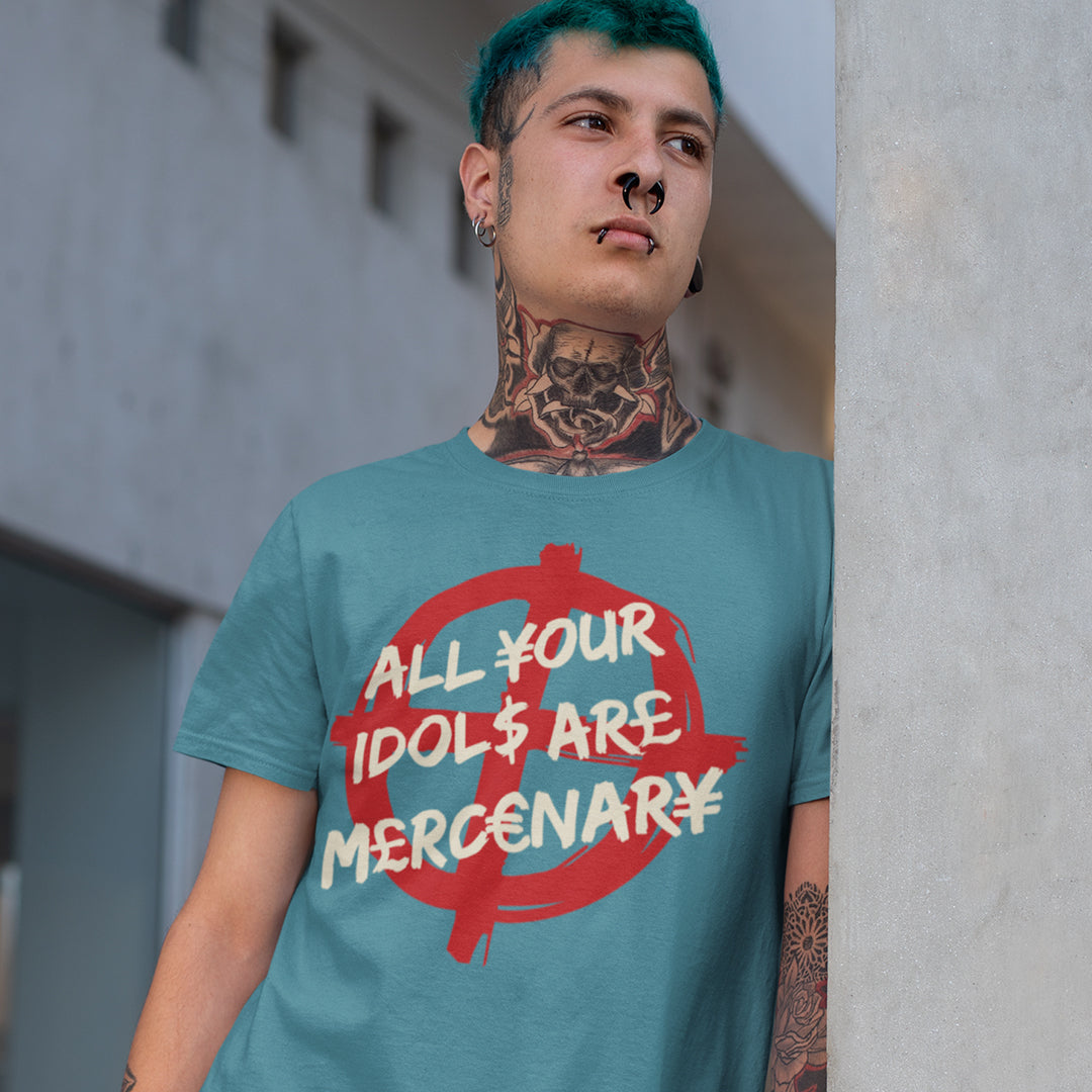 Person wearing a teal t-shirt with a graphic design and text, standing against a concrete wall. This broken society t shirt shows the dark side of capitalism. Why are we looking up to people that put money before integrity, what is it we admire, their bank accounts ? Are there any products that celebrities or sports personalities wouldn't sell ? Made from 100% organic ring-spun cotton, this anti capitalism t shirt is unisex, high-quality, super comfy, and best of all, eco-friendly.