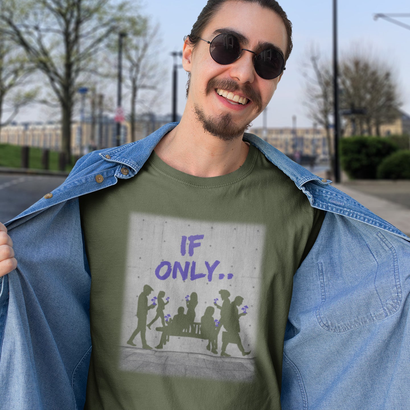 Man wearing a khaki t-shirt with 'IF ONLY...' design outdoors. An anti mobile phone abuse t shirt in a stencil graffiti art design. Wouldn't it be a better world if people had something more mind expanding to be obsessed with other than a mobile phone. Made from 100% organic ring-spun cotton, this anti mobile phone abuse t shirt is unisex, high-quality, super comfy, and best of all, eco-friendly.