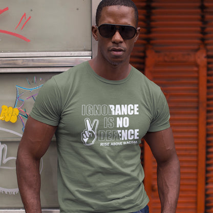 Man wearing a khaki t-shirt with a message in front of a graffiti-covered wall. An anti-racist t-shirt to remind people that ignorance is no defence against prejudice. This unique racial equality t-shirt design promotes understanding and brotherhood to achieve peace in the world. Made from 100% organic ring-spun cotton, this anti racism t-shirt is unisex, high-quality, super comfy, and best of all, eco-friendly.