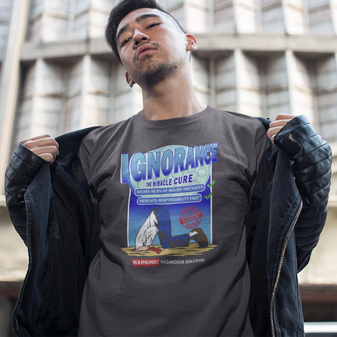 Person wearing a t-shirt with a graphic design and text, standing outdoors. This broken society t shirt comes in the form of a cleaning solution. A very satirical and sarcastic view of how ignorance has become the number one reaction to most of the problems facing modern society. Burying your head in the sand has always been a very popular but hazardous solution. Made from 100% organic ring-spun cotton, these social issues t shirts are unisex, high quality, super comfy, and best of all, eco-friendly.