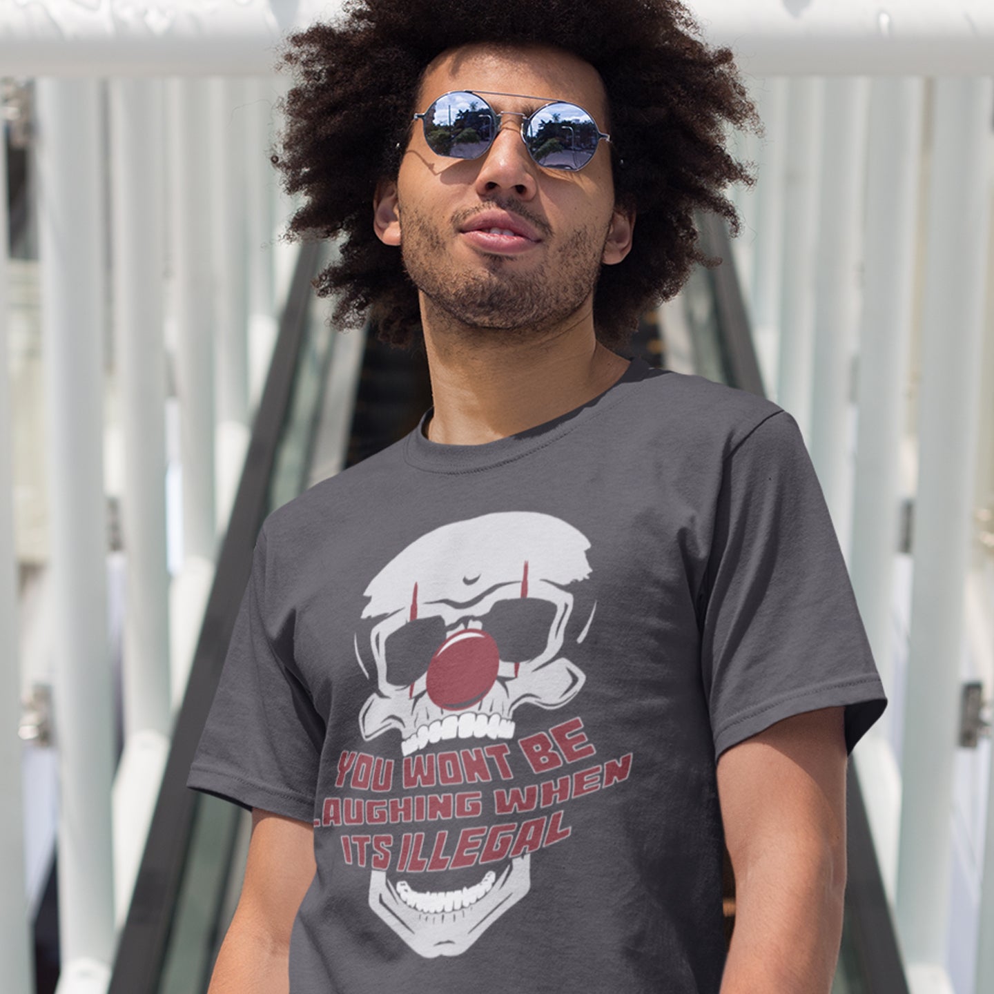 Man on a bridge wearing an anthracite t shirt. This civil liberties t shirt opposes too much government power. A satirical view of the ever increasing control and suppression of diversity. A unique urban art t shirt design, ideal for everyone who believes that fear based political policies are squeezing the fun out of life and killing the essence of society ? Made from 100% organic ring-spun cotton, these funny activist t shirts are unisex, high-quality, super comfy, and best of all, eco-friendly.