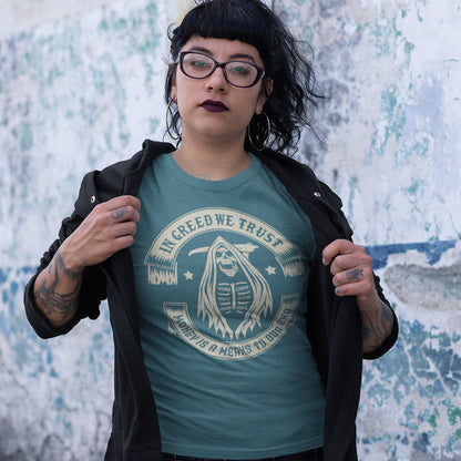 Person wearing a teal t-shirt with a graphic design and text, standing against a textured wall. A broken society t shirt implying we have made greed our new God. If you believe our obsession with money is lowering the standards of society, help create social awareness with this anti capitalism t shirt. Could it be that money worship will be the end of us ? Made from 100% organic ring-spun cotton, this broken society t shirt is unisex, high quality, super comfy, and best of all, eco-friendly.