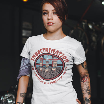 Person wearing a white t-shirt with graphic design and text. A conspiracy theory t shirt exposing indoctrination as the foundation of modern society. What we believe before we realise we are being lied to shapes our lives until we take back our own opinions. Made from 100% organic ring-spun cotton, this non conformist t shirt is unisex, high quality, super comfy, and best of all, eco-friendly.