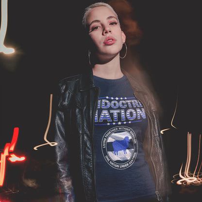 Person wearing a blue t-shirt with text and graphics, standing against a dark background with neon lights. A political t-shirt with satirical look at nationalism, an insight into a very dark future for any nation under a controlling government. Display your social awareness with this unique design. Made from 100% organic ring-spun cotton, this political t-shirt is unisex, high-quality, super comfy, and best of all, eco-friendly.