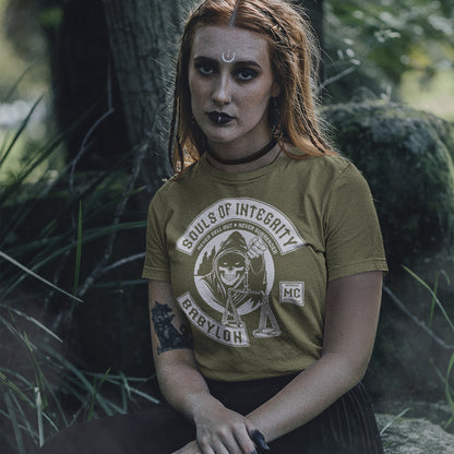 Person wearing a 'Sons of Integrity Babylon MC' t-shirt in a forest setting. A social awareness t shirt promoting ethics and morality. A spoof motorcycle club design for people who still have integrity. This design satirically representing how few people are left with a moral conscience in a corrupt world, or as the Rastafarians call it, BABYLON. Made from 100% organic ring-spun cotton, these social issues t shirts are unisex, high-quality, super comfy, and best of all, eco-friendly.