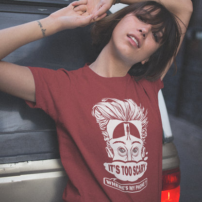 Person wearing a burgundy t-shirt with a graphic design and text, leaning against a vehicle. An anti-mobile phone abuse t-shirt highlighting the effects on the mind of smart phone over use in the place of thinking. A view of how mobile phones have taken over thinking and left us with dark unexplored corridors in our minds. Made from 100% organic ring-spun cotton, this social awareness t-shirt is unisex, high-quality, super comfy, and best of all, eco-friendly.