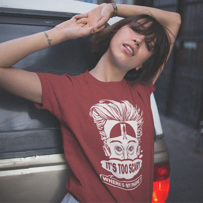 Person wearing a red t-shirt with a graphic design and text, leaning against a vehicle. An anti mobile phone abuse t-shirt highlighting the effects on the mind of smart phone over use in the place of thinking. A view of how mobile phones have taken over thinking and left us with dark unexplored corridors in our minds. Made from 100% organic ring-spun cotton, this social awareness t-shirt is unisex, high-quality, super comfy, and best of all, eco-friendly.