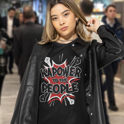 Woman in shopping centre. This anti government t shirt packs a punch with this humorous play on the slogan 'Power to the people', with a comic book twist. Support true democracy with this funny political message. Made from 100% organic ring-spun cotton, this unisex non conformist t shirt is a total must-have. It's high-quality, super comfy, and best of all, eco-friendly