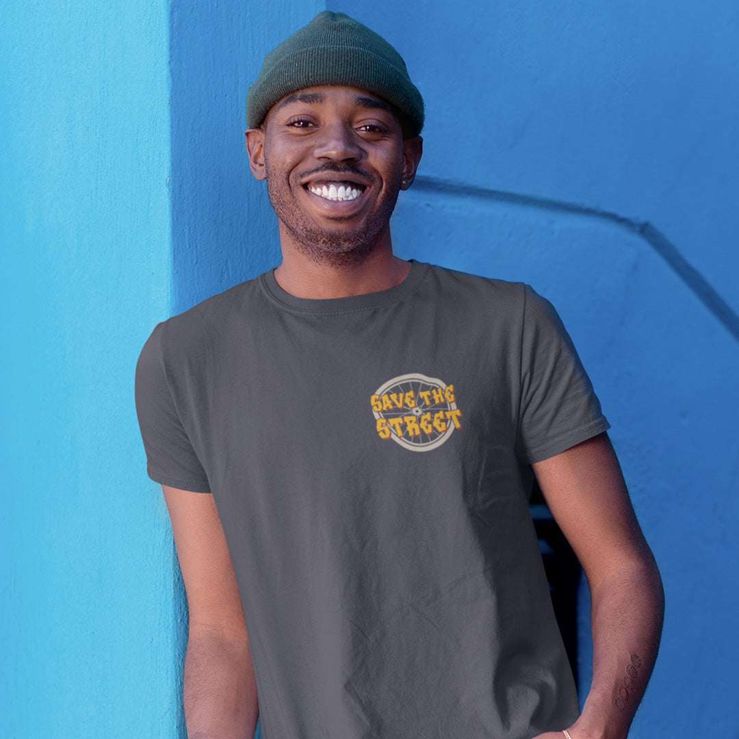Man wearing a grey t-shirt with 'Save the Street' logo against a blue wall. This street art t shirt stencil represents inner city street life as a culture of it's own. There is a ground level reality mixed with trustworthy honestly at street level in towns and cities across the planet. Wherever you are in the world, may the street be with you. Made from 100% organic ring-spun cotton, this urban art t shirt is unisex, high-quality, super comfy, and best of all, eco-friendly.